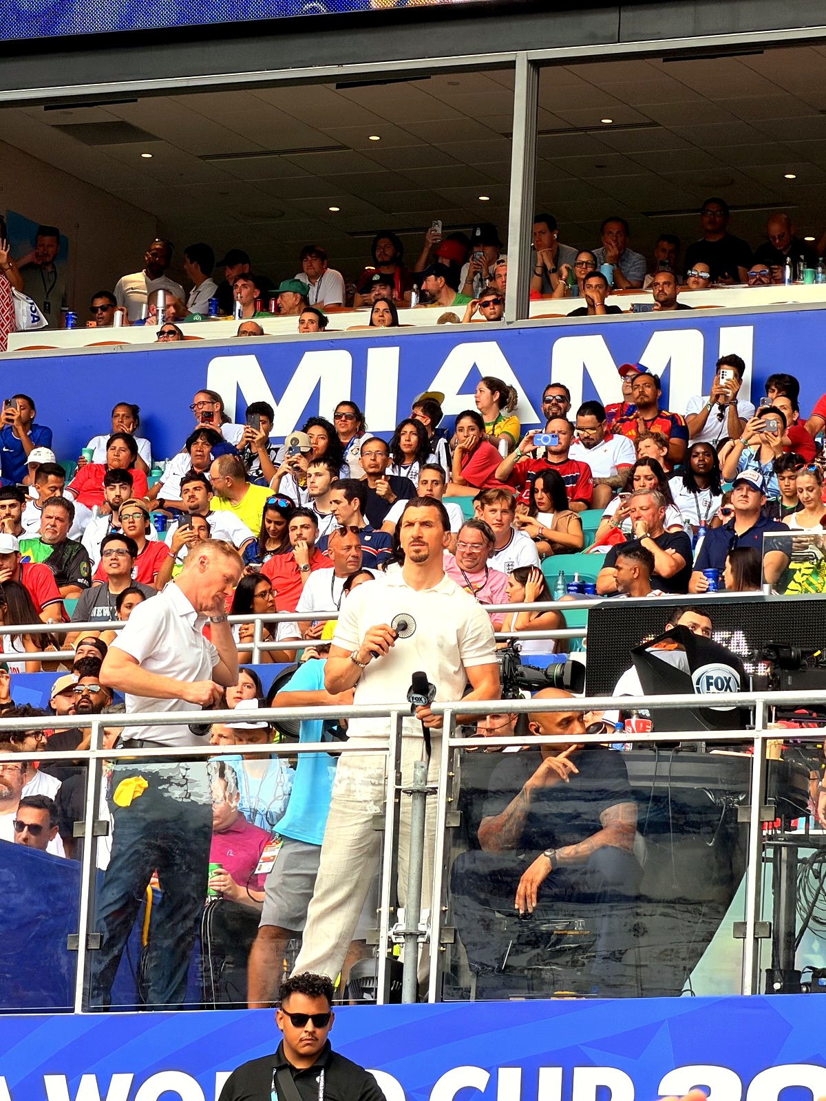 Matchday in Miami. the broadcast set, the stand, and a tournament at full volume inside the ground.