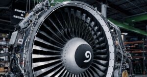 CFM56 engine suspended on a shop crane in an MRO facility. Aviation, GCC Media.