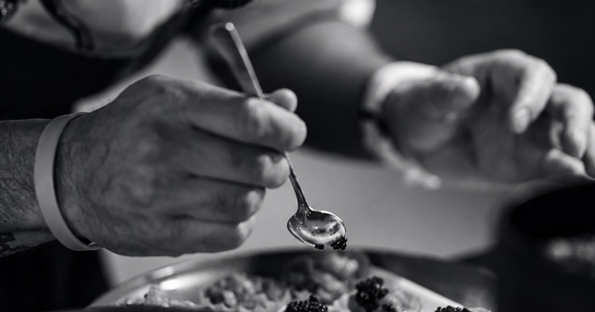 Chef plating a course in a restaurant kitchen. Business and Lifestyle, GCC Media.