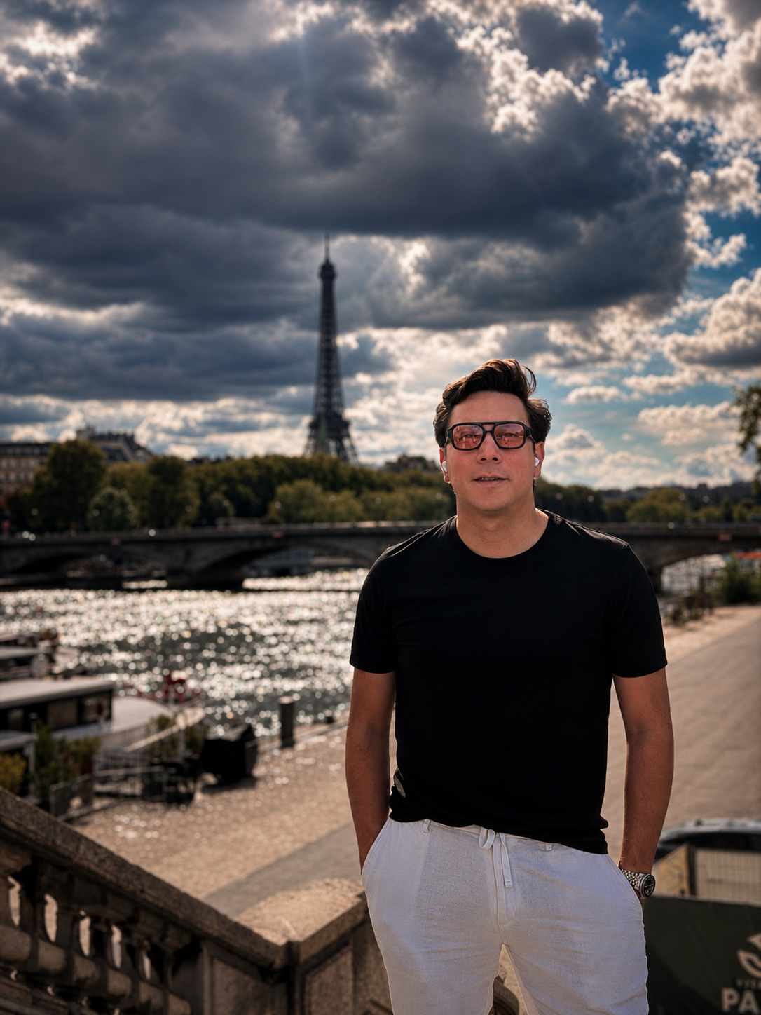 Carlos by the Seine in Paris with the Eiffel Tower in the distance